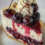 A beautifully garnished Elegant Cherry Cheesecake with fresh cherries and whipped cream.