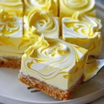 Close-up of lemon marbled cheesecake bars with swirls of lemon curd on top
