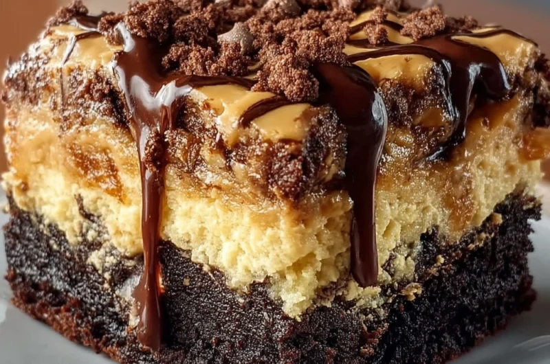 Chocolate peanut butter ooey gooey butter cake slice topped with caramel drizzle.
