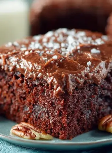 Chocolate Buttermilk Cake topped with rich frosting on a decorative plate