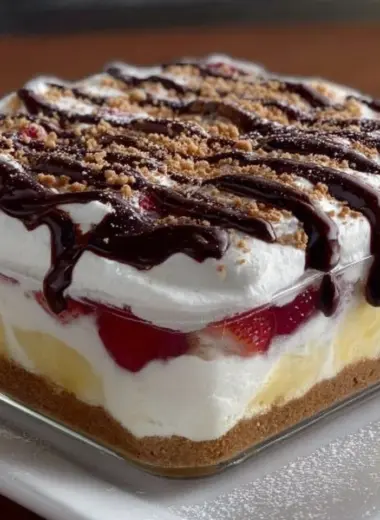 Delicious layered banana split dessert with bananas, ice cream, and toppings