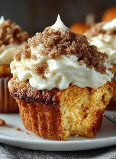 Freshly baked Pumpkin Cream Cheese Muffins on a wooden table.